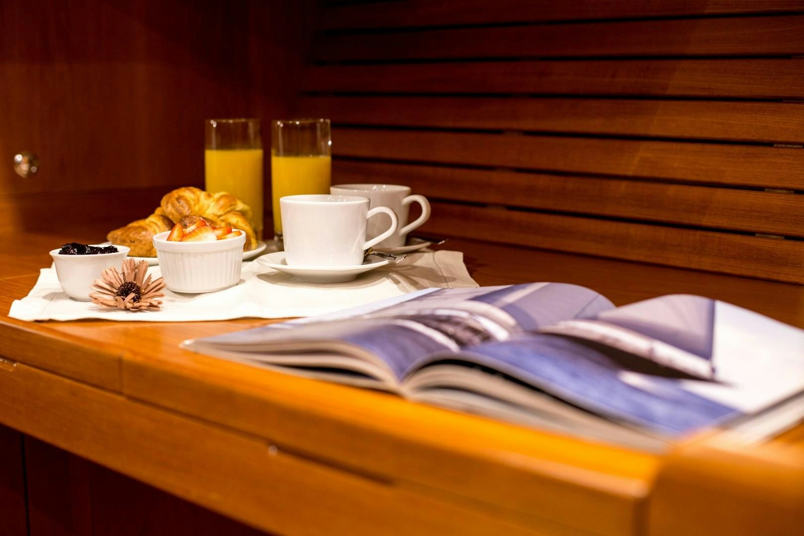 a tray of food and drinks aboard UMIKO Yacht for Sale