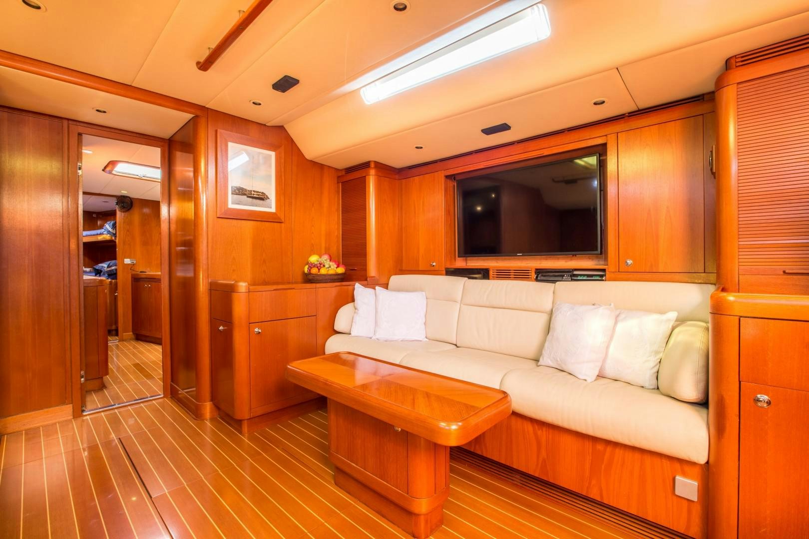 a living room with a couch and a table aboard UMIKO Yacht for Sale
