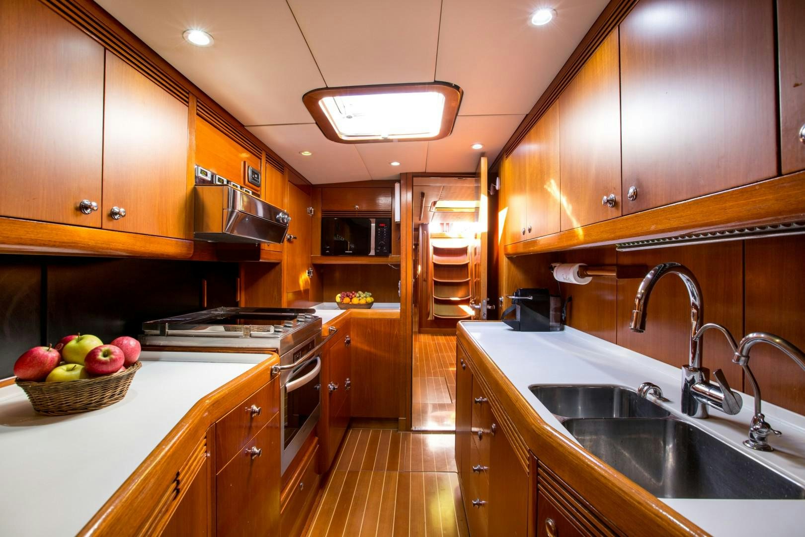 a kitchen with wooden cabinets aboard UMIKO Yacht for Sale