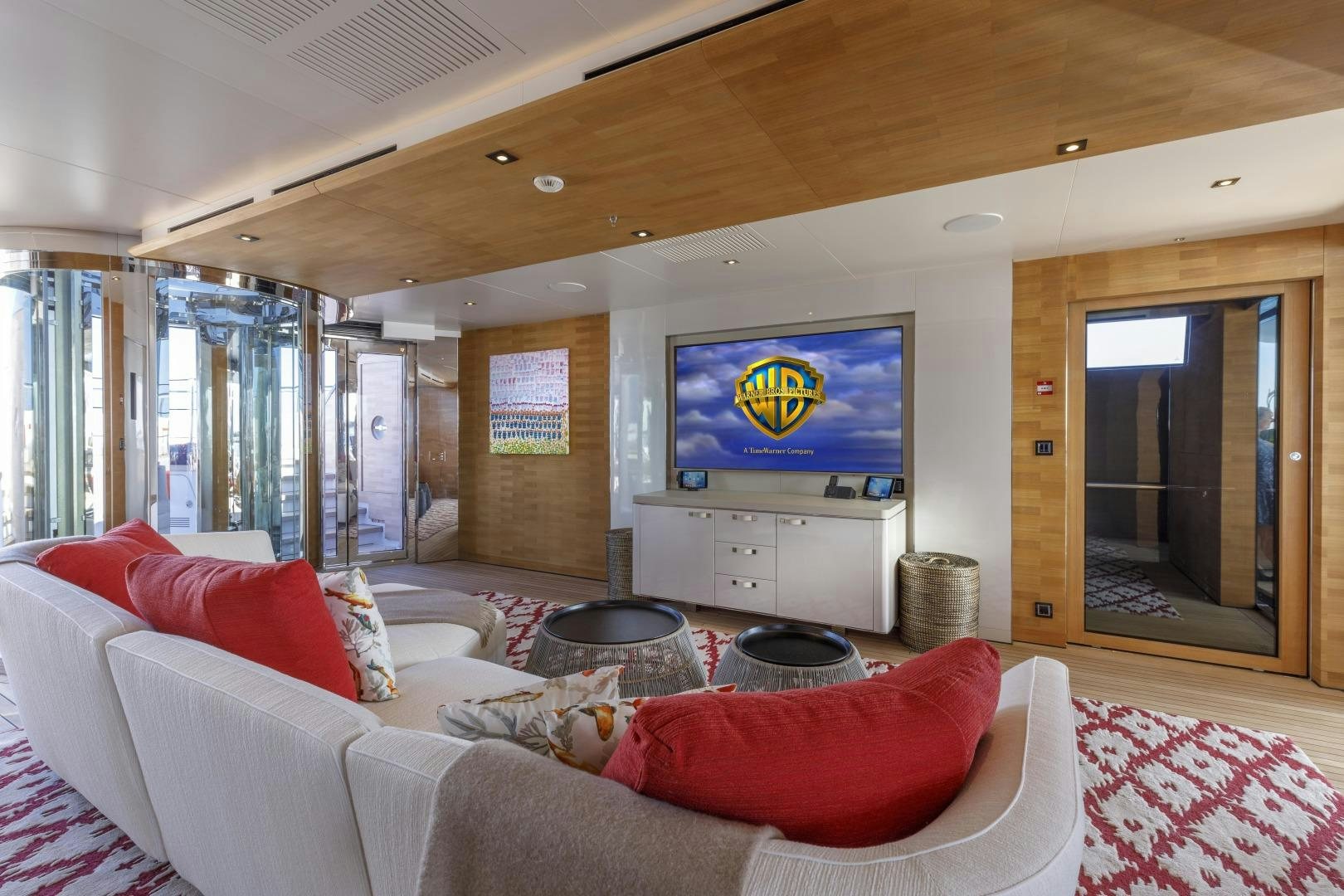 a living room with a large screen aboard ATOMIC Yacht for Sale