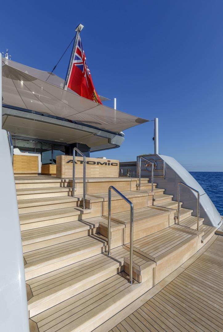 a flight of stairs leading to a flag on a ship aboard ATOMIC Yacht for Sale