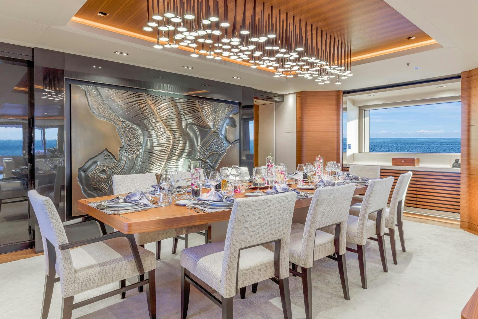 a large dining room with a large table and chairs aboard ATOMIC Yacht for Sale