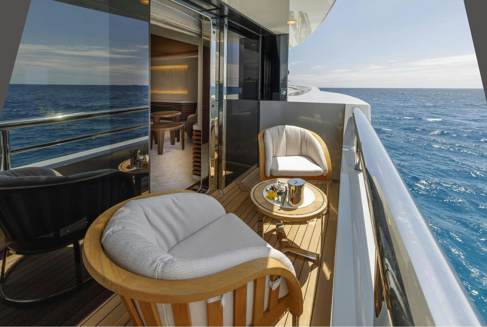 a boat with a table and chairs on the deck aboard ATOMIC Yacht for Sale