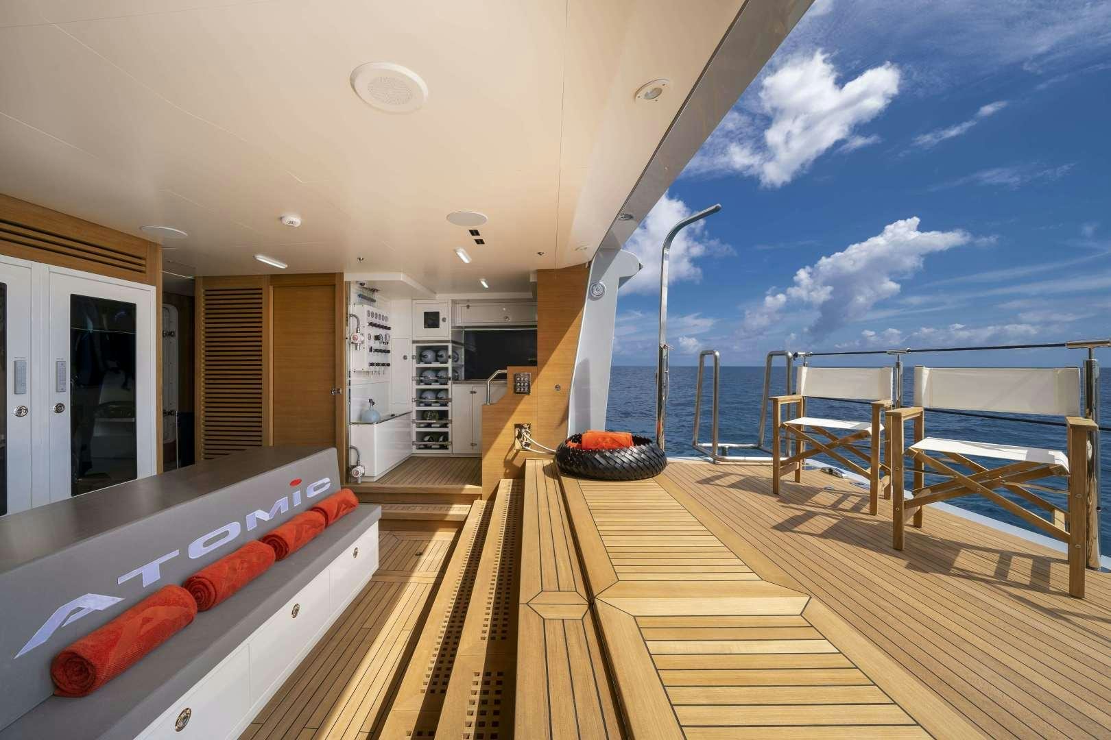 a deck with a view of the ocean and the deck aboard ATOMIC Yacht for Sale