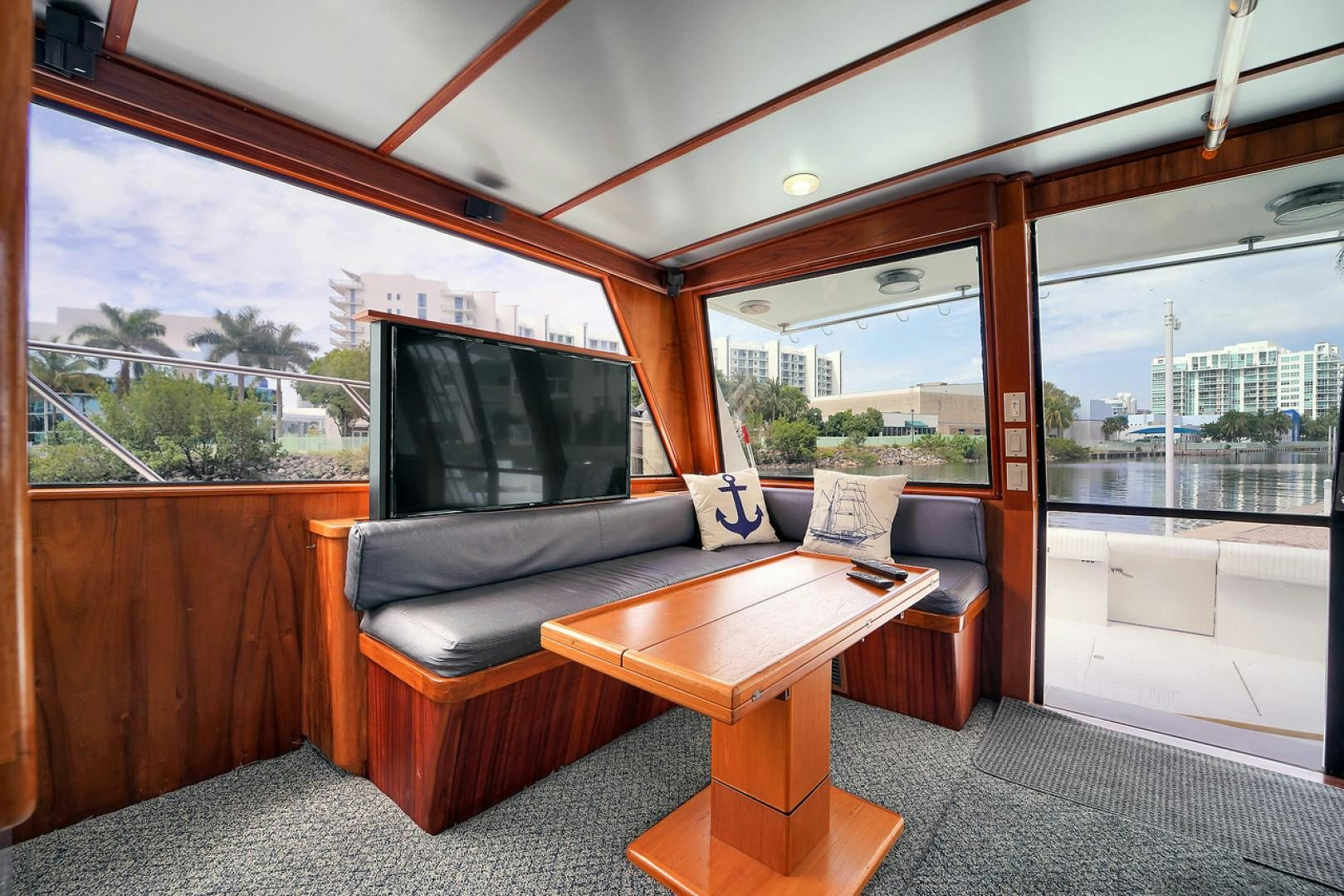 a living room with a couch and a tv aboard STEALIN TIME Yacht for Sale