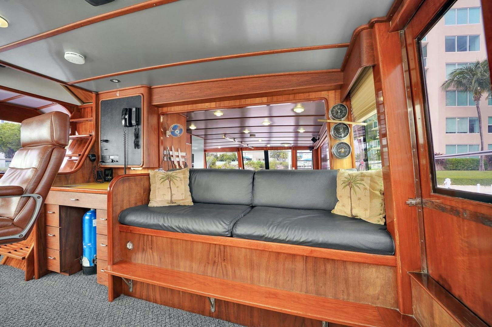 a living room with a leather couch aboard STEALIN TIME Yacht for Sale