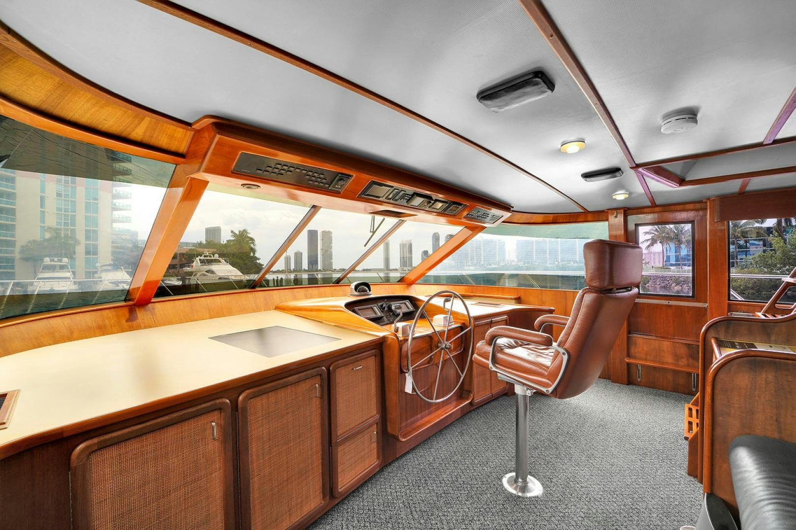 a room with a chair and a table and a bench aboard STEALIN TIME Yacht for Sale