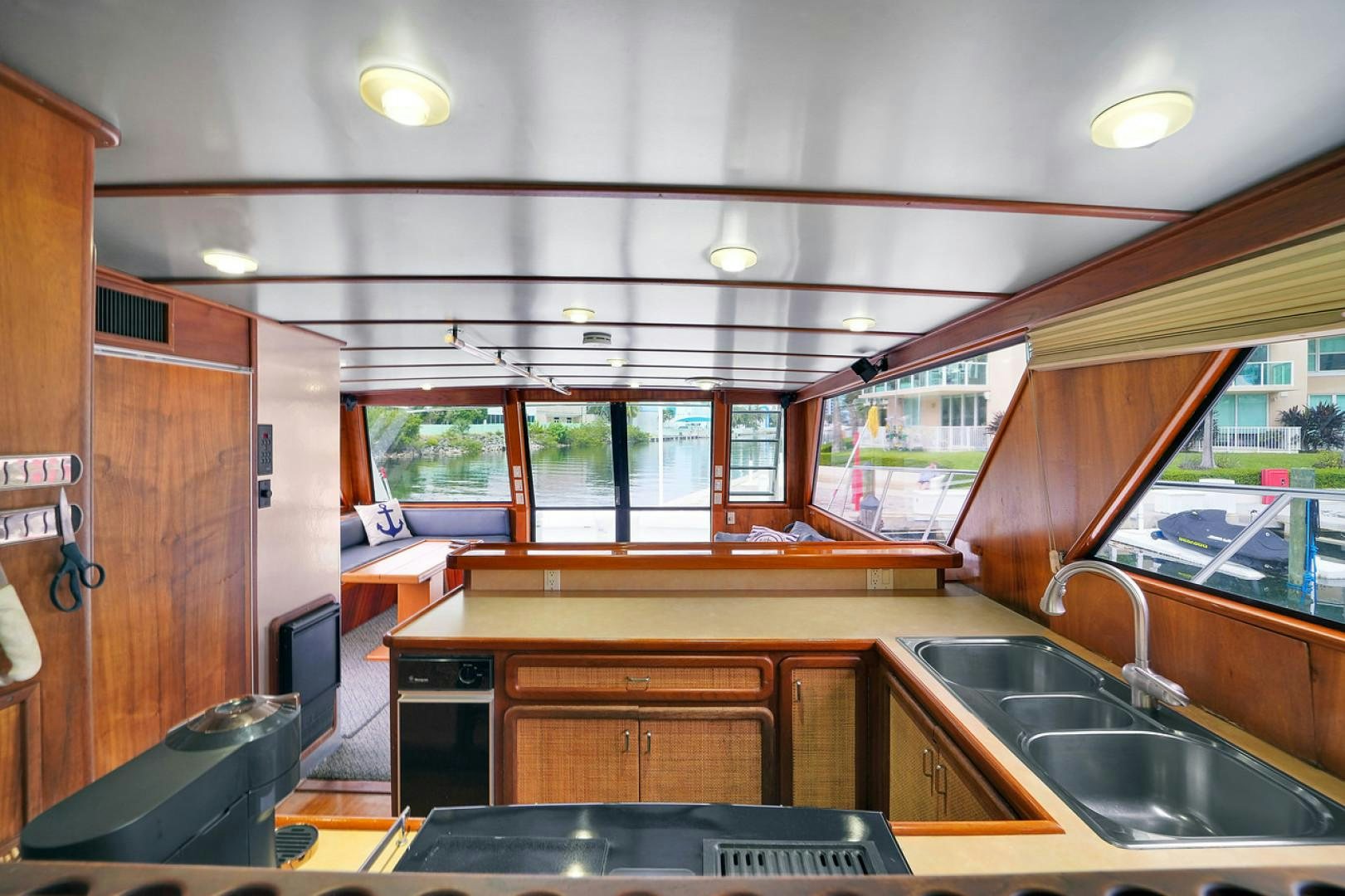 a kitchen with wooden cabinets aboard STEALIN TIME Yacht for Sale