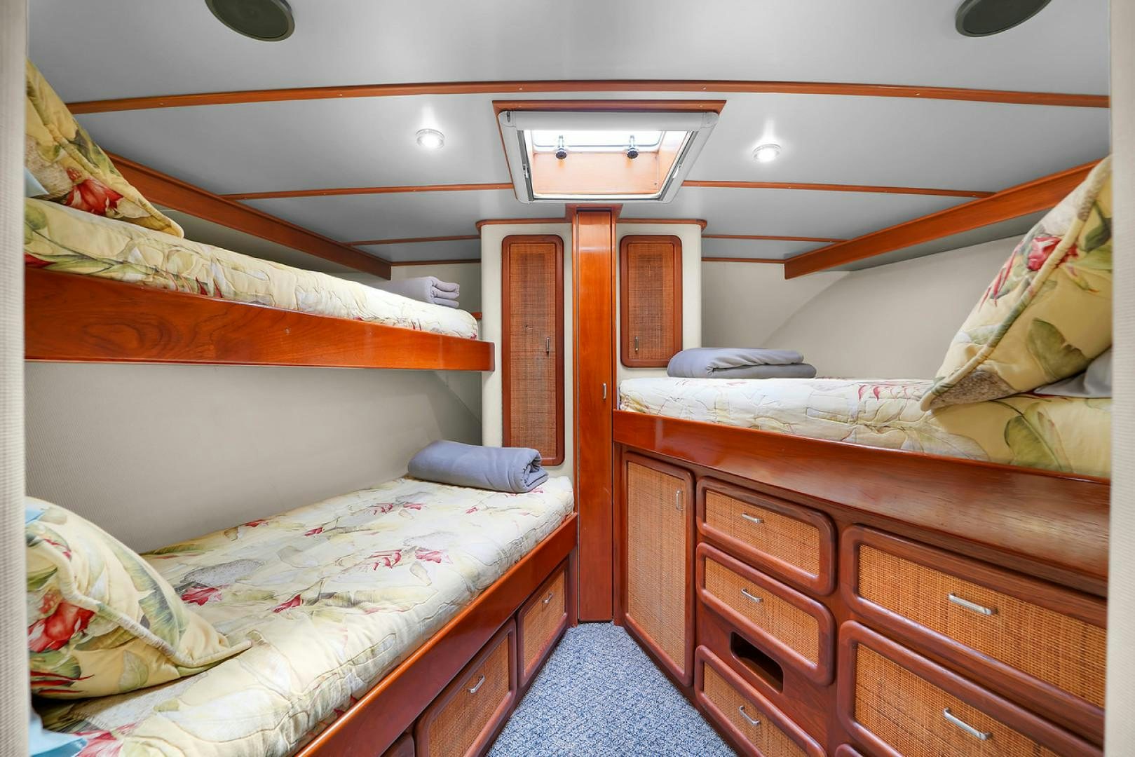 a room with a bed and a dresser aboard STEALIN TIME Yacht for Sale