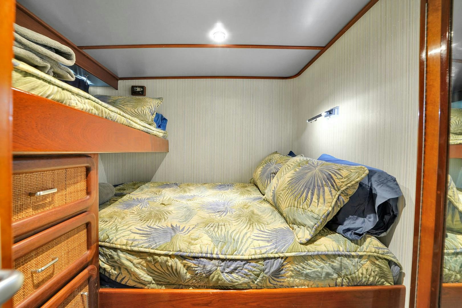 a bedroom with a bed and a dresser aboard STEALIN TIME Yacht for Sale
