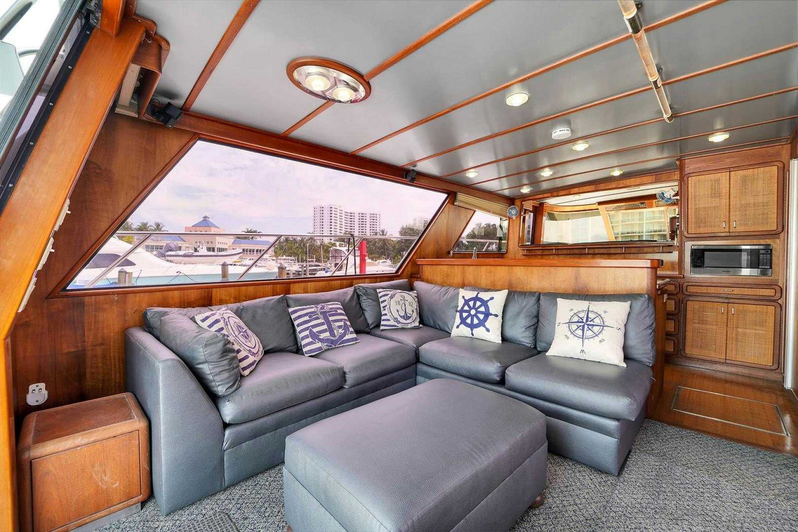 a living room with a large window aboard STEALIN TIME Yacht for Sale
