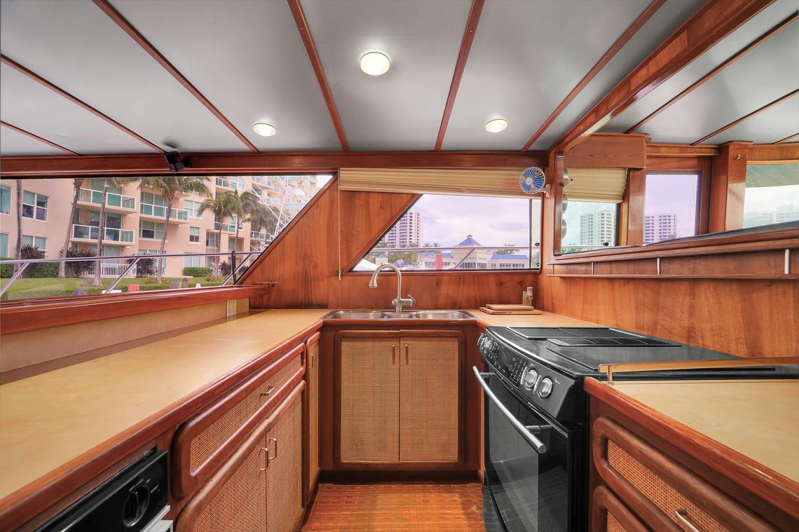 a kitchen with wooden cabinets aboard STEALIN TIME Yacht for Sale