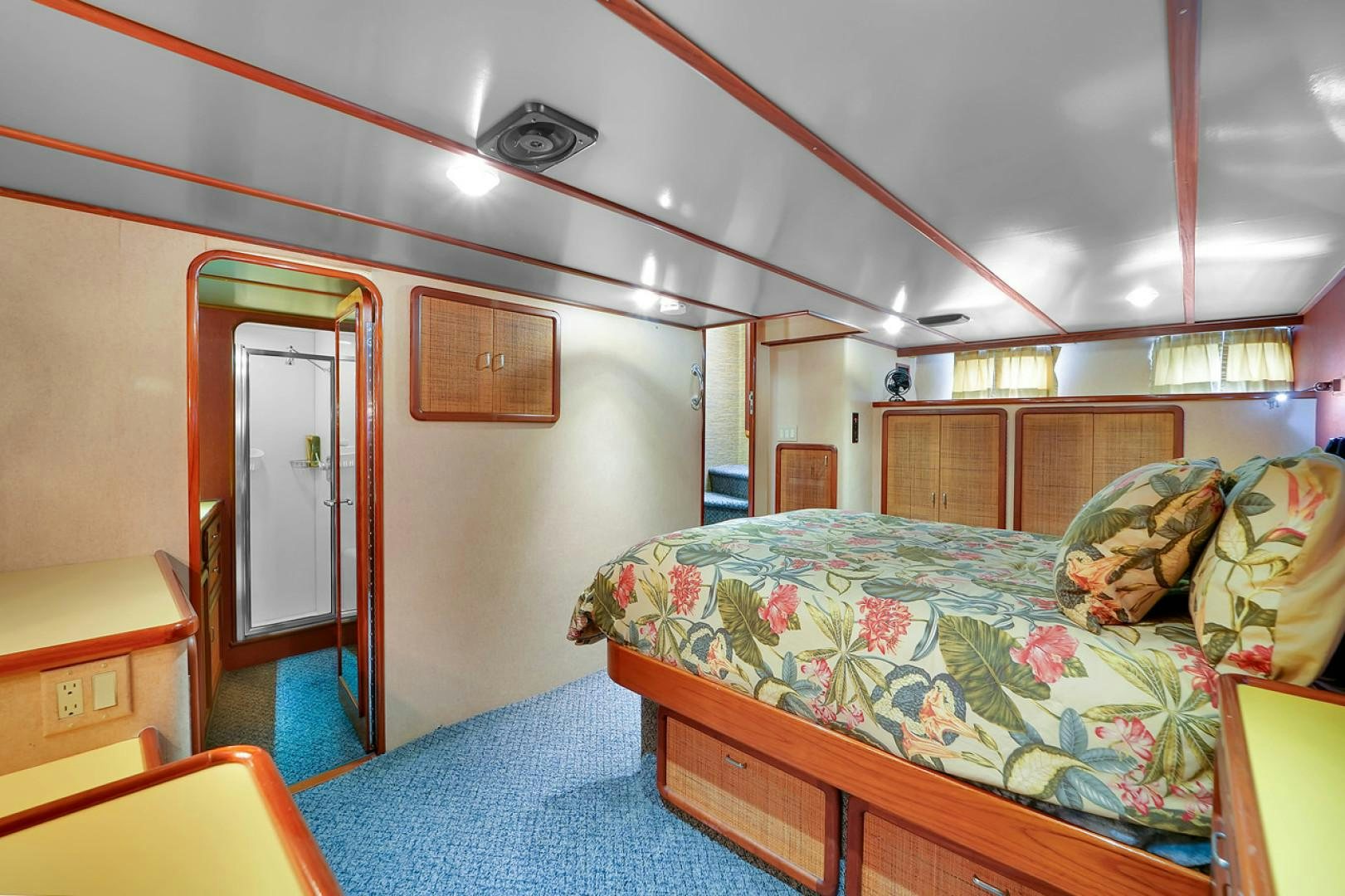 a bedroom with a bed and a desk aboard STEALIN TIME Yacht for Sale