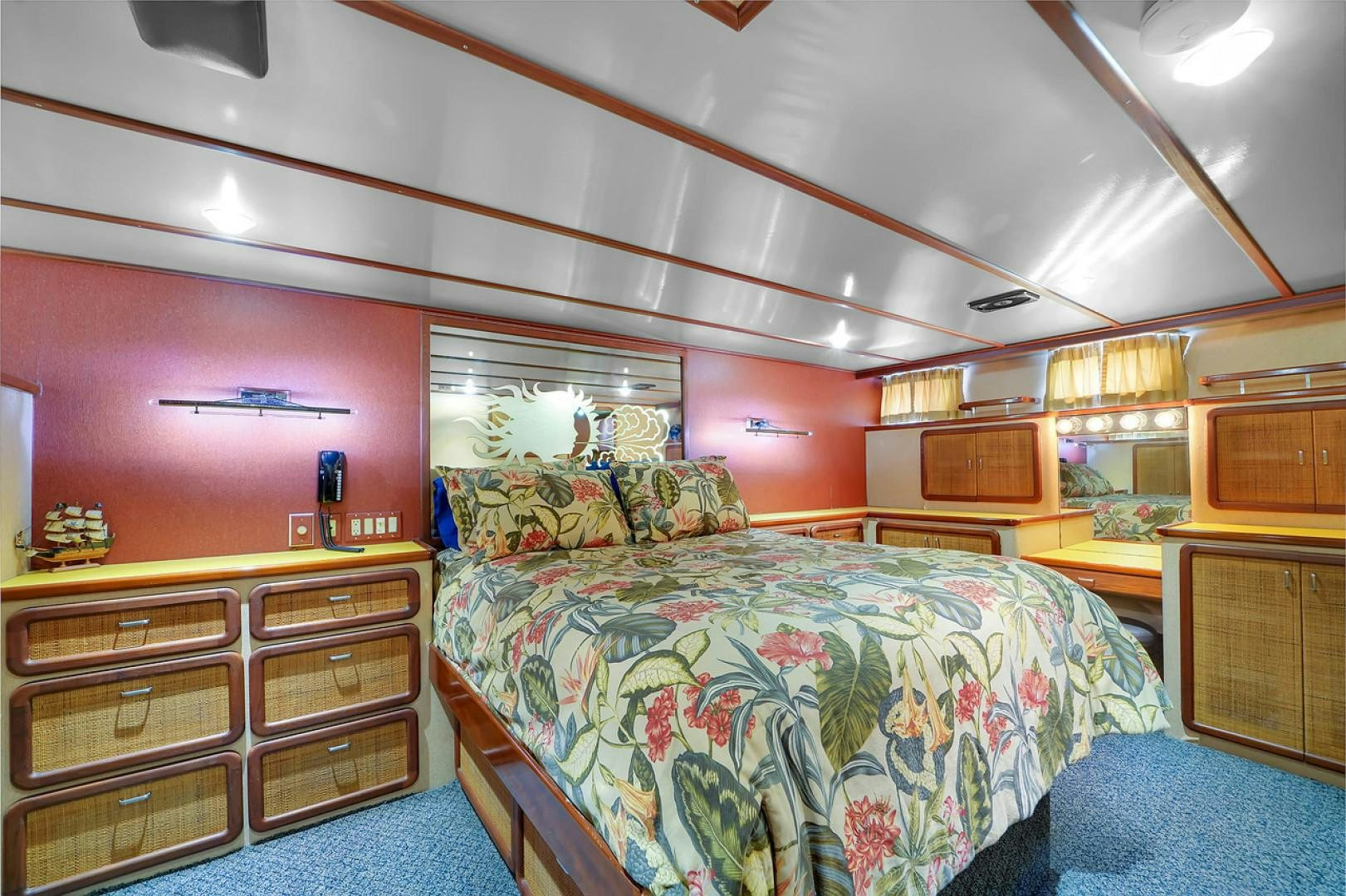 a bedroom with a bed and a dresser aboard STEALIN TIME Yacht for Sale