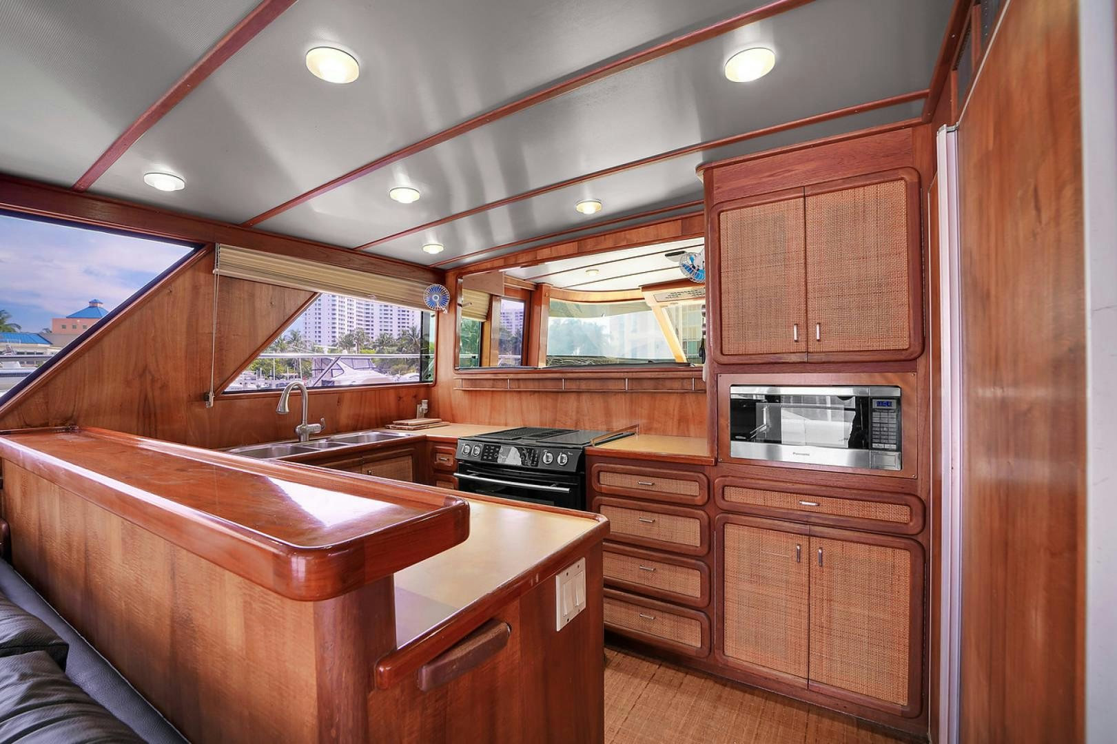 a kitchen with wooden cabinets aboard STEALIN TIME Yacht for Sale