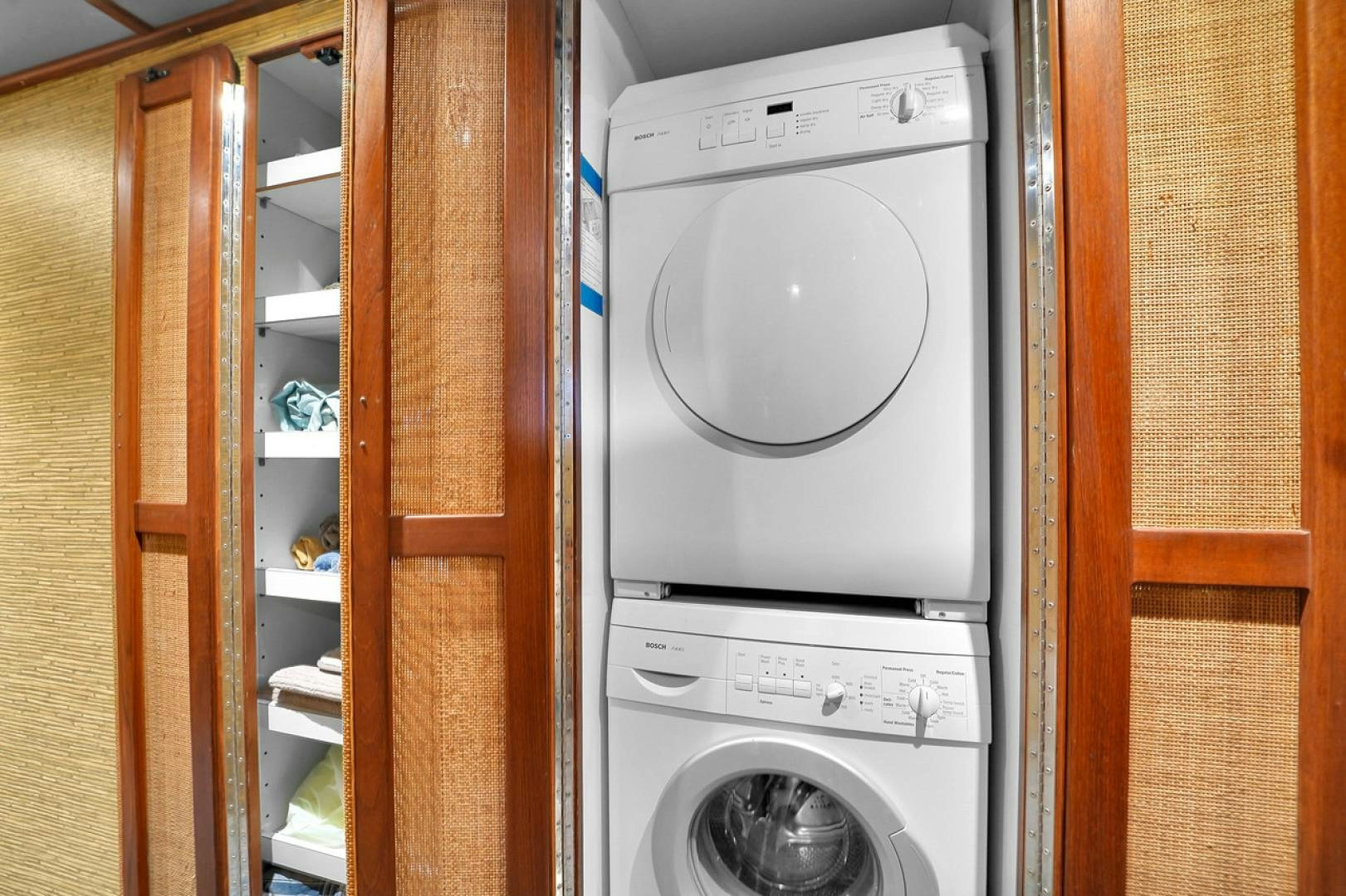 a white washing machine in a room aboard STEALIN TIME Yacht for Sale