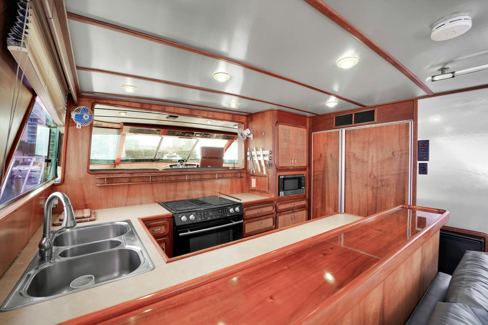 a kitchen with wooden cabinets aboard STEALIN TIME Yacht for Sale