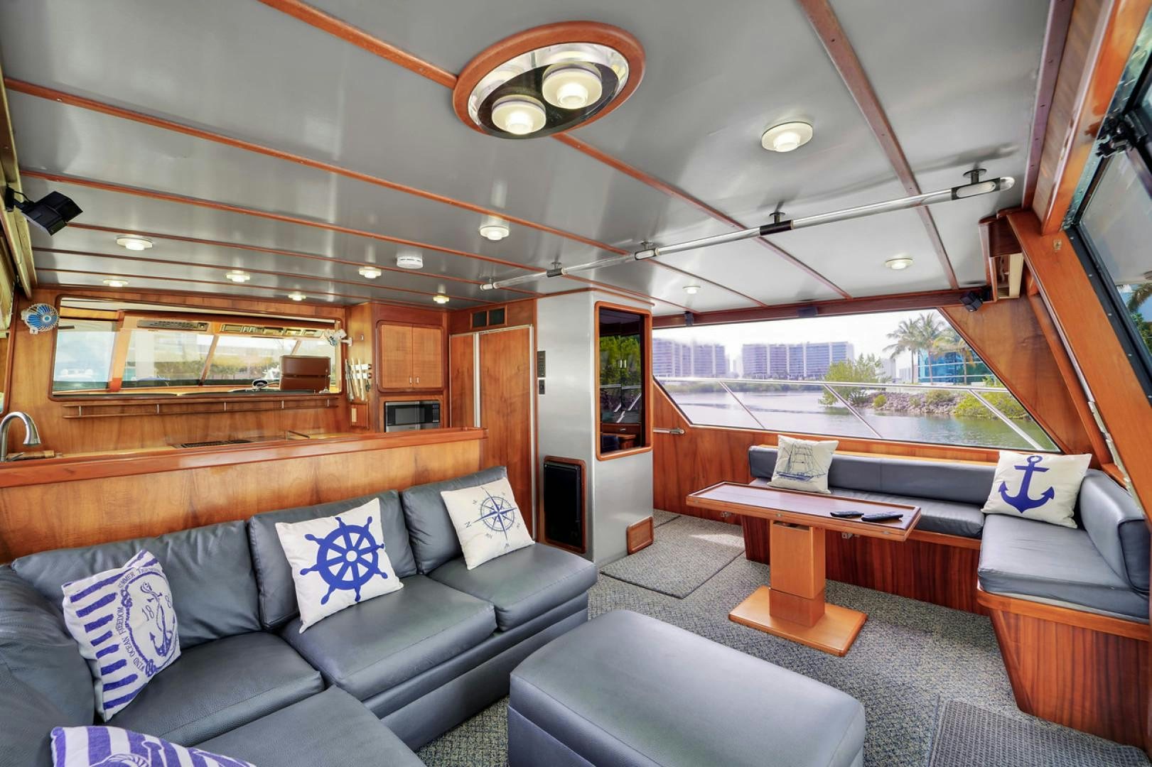 a living room with a large window aboard STEALIN TIME Yacht for Sale