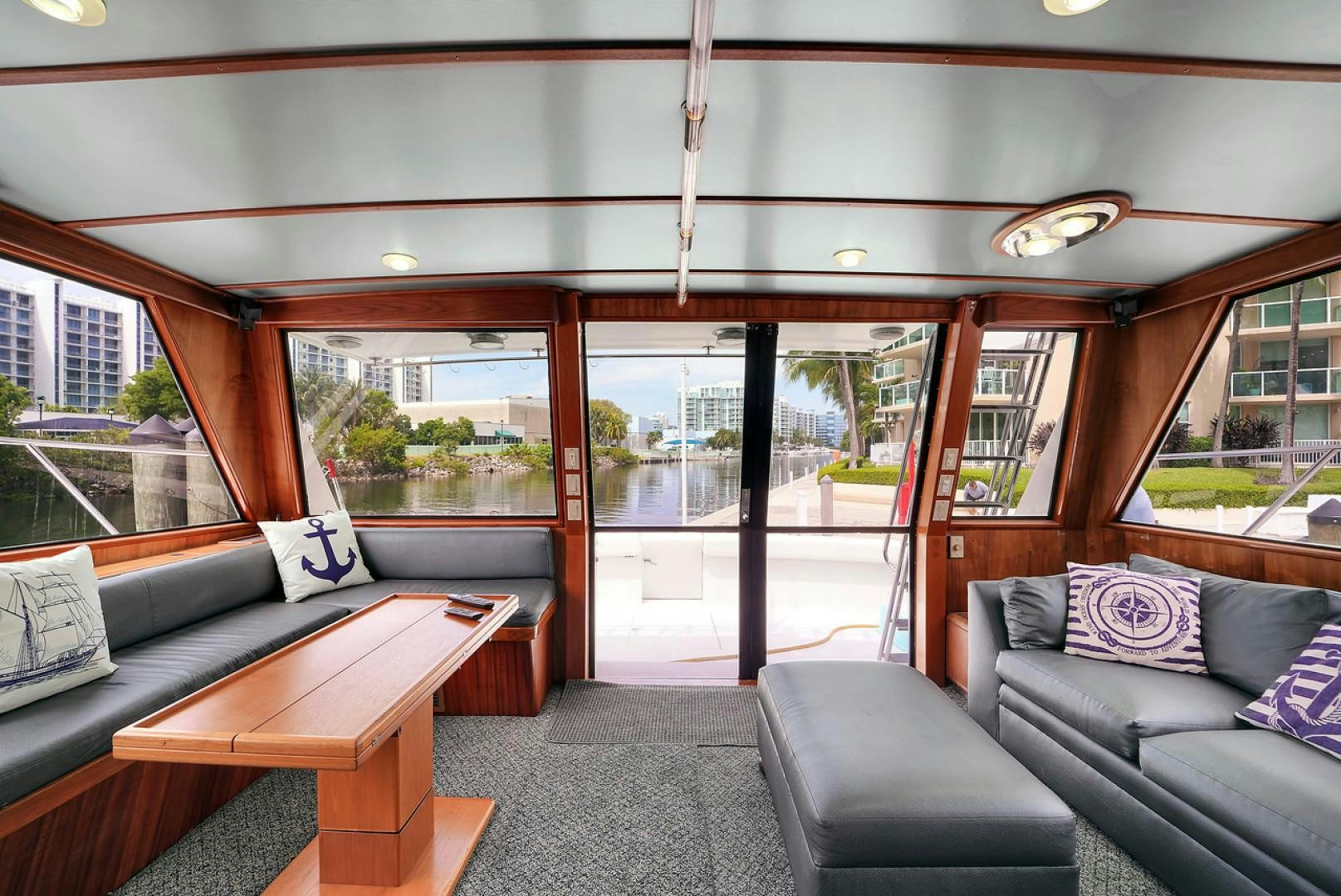 a room with a couch and a table and a window aboard STEALIN TIME Yacht for Sale