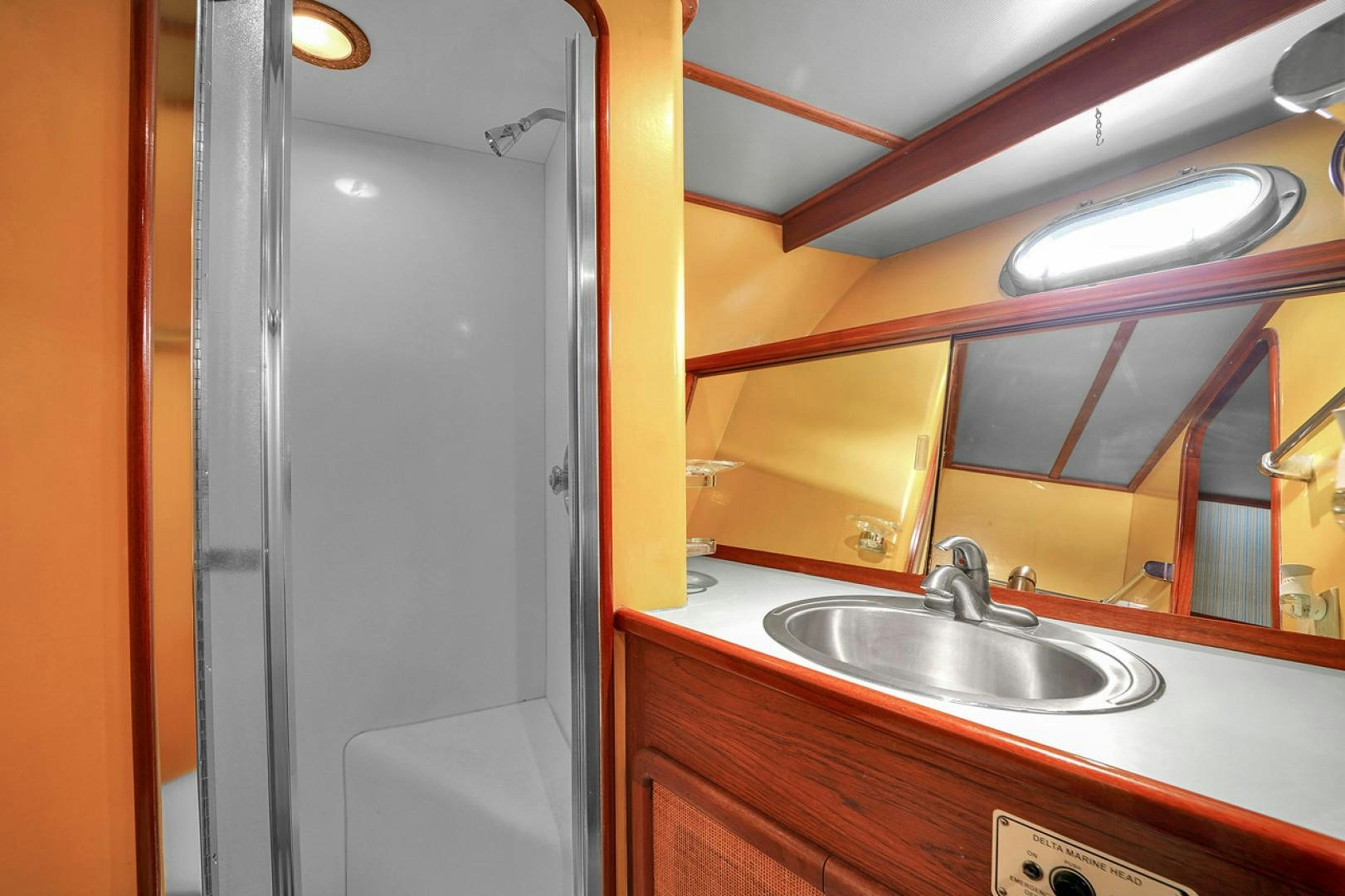 a bathroom with a sink and a mirror aboard STEALIN TIME Yacht for Sale