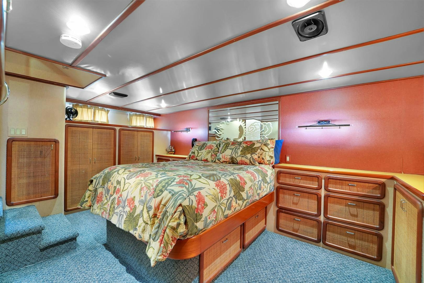 a bedroom with a bed and dresser aboard STEALIN TIME Yacht for Sale