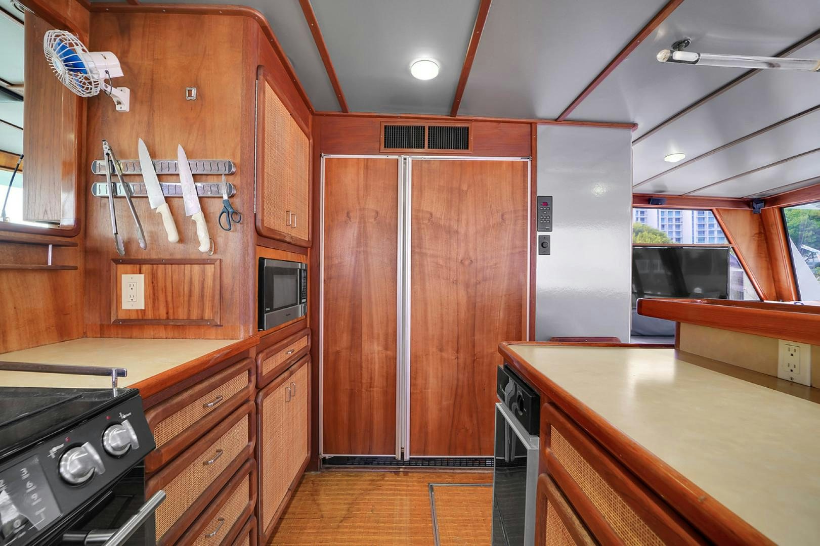 a kitchen with wooden cabinets aboard STEALIN TIME Yacht for Sale
