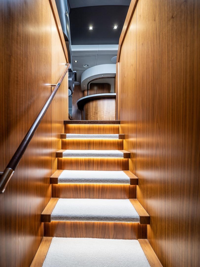 a wooden staircase with a metal railing aboard TATIS Yacht for Sale