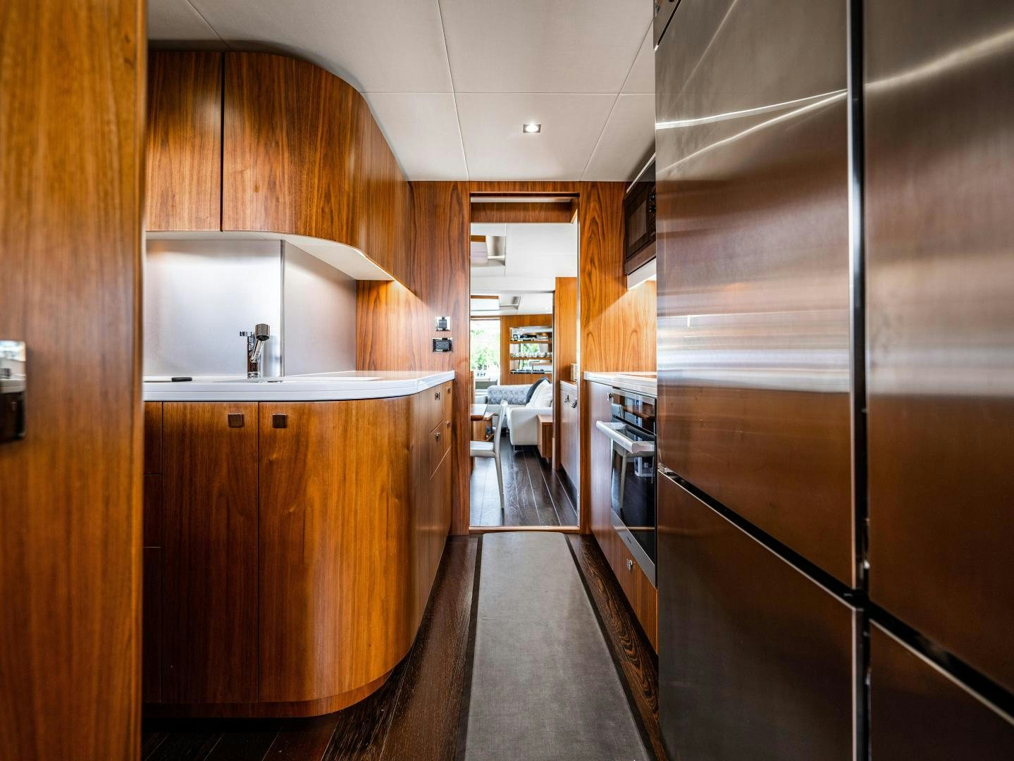 a kitchen with wooden cabinets aboard TATIS Yacht for Sale