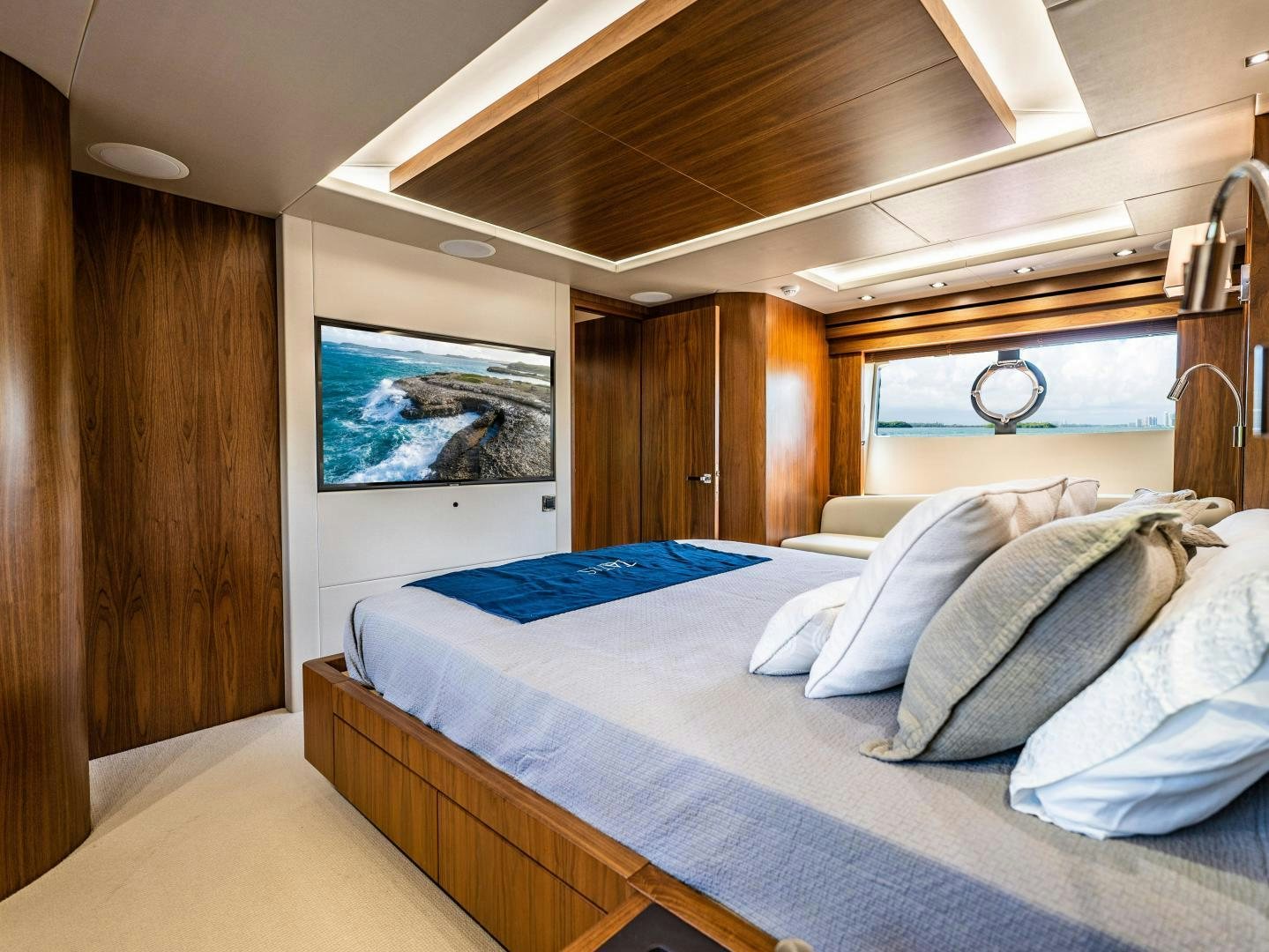 a room with a bed and a wood wall aboard TATIS Yacht for Sale