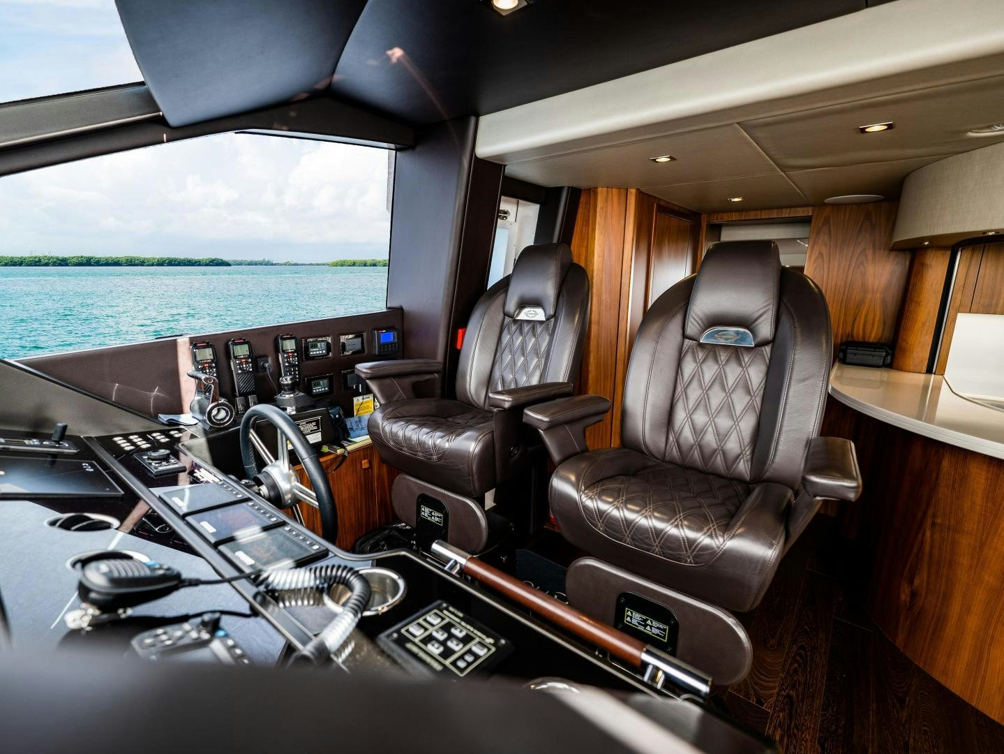 a cockpit with a seat and steering wheel aboard TATIS Yacht for Sale