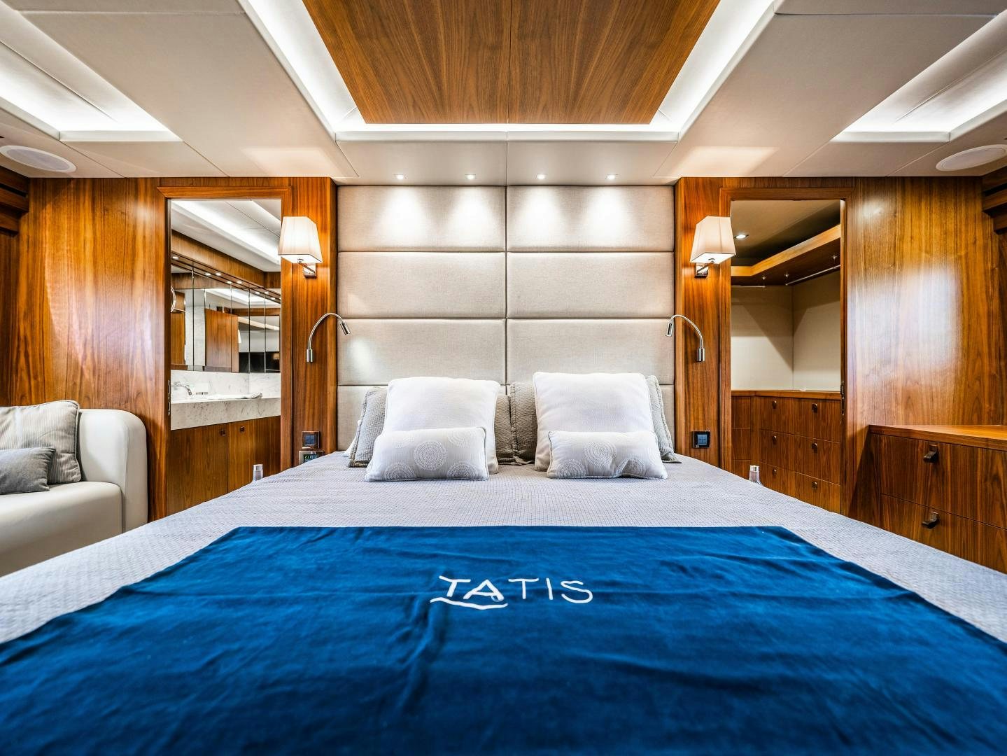 a bed with blue sheets aboard TATIS Yacht for Sale