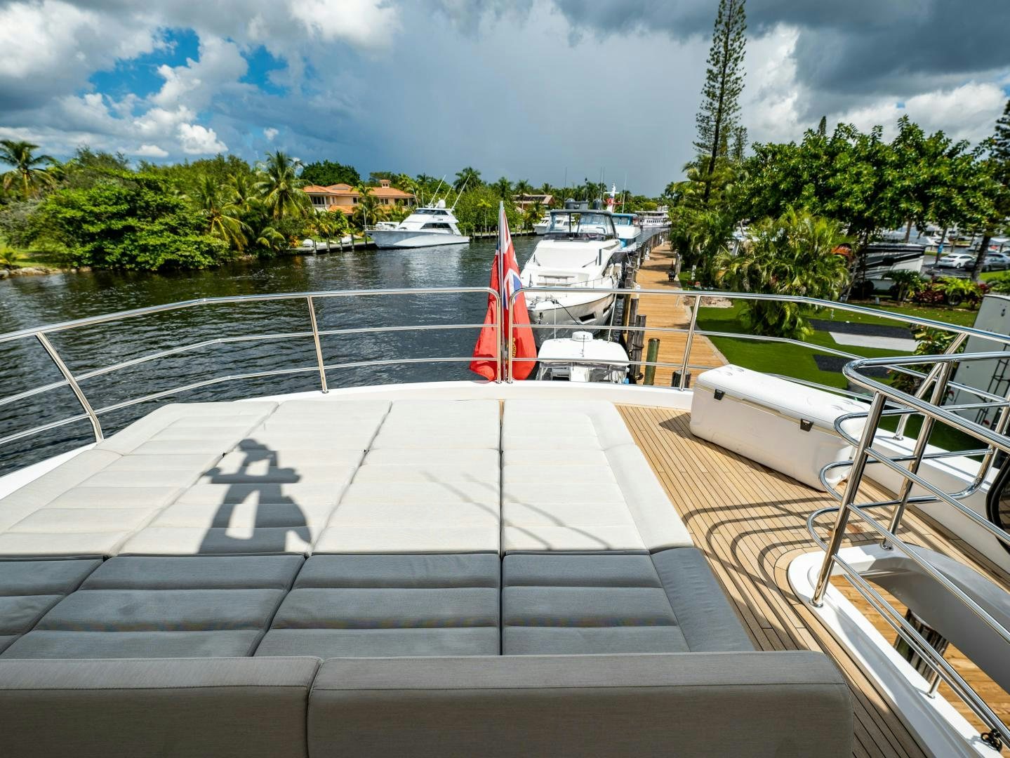 a deck with a boat and a flag on it aboard TATIS Yacht for Sale