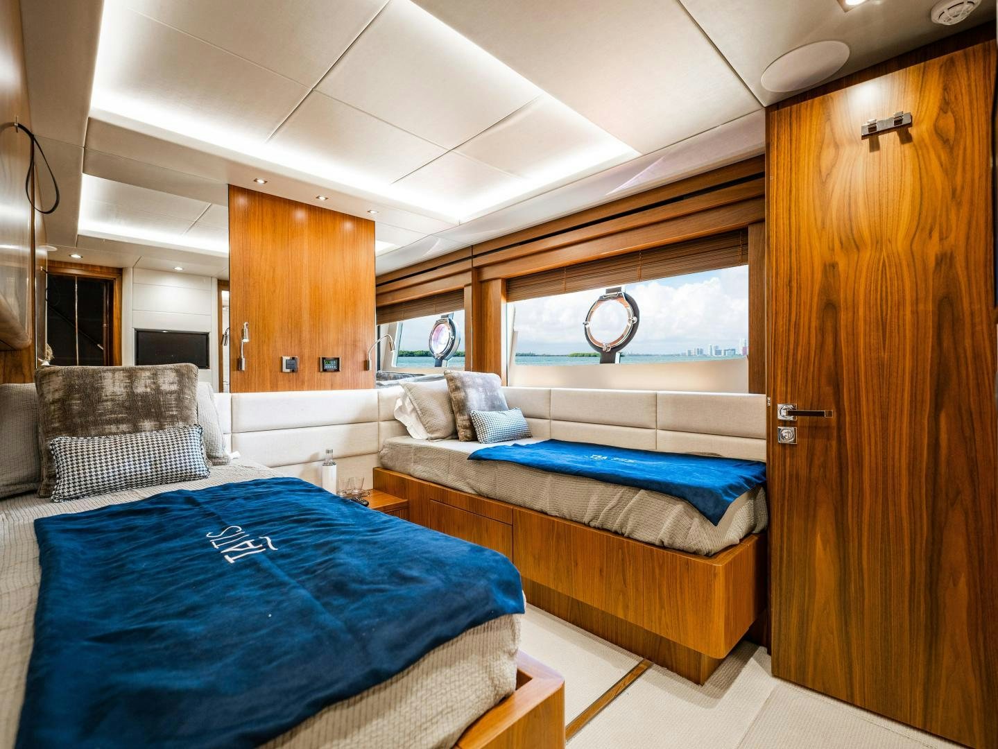 a bedroom with a bed and a closet aboard TATIS Yacht for Sale