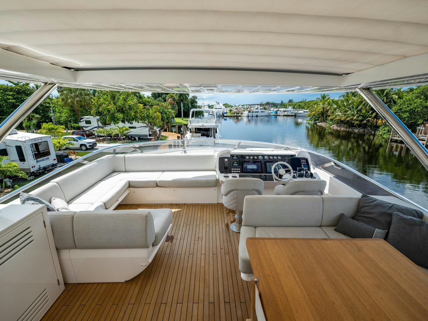 a room with a deck and a view of a body of water aboard TATIS Yacht for Sale