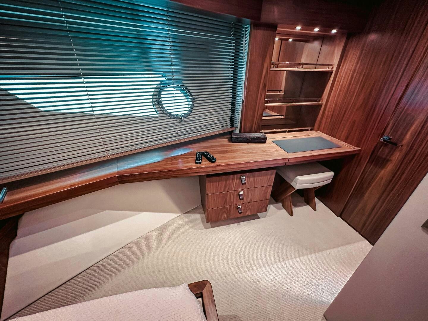 a bed with a desk aboard TATIS Yacht for Sale