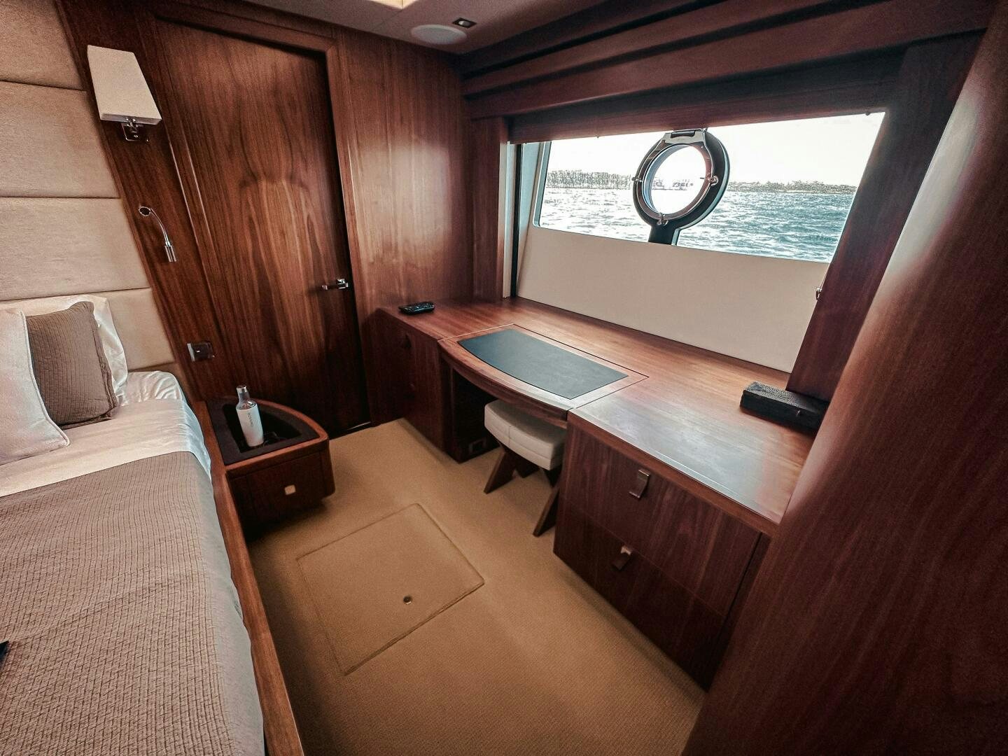 a room with a bed and a desk aboard TATIS Yacht for Sale