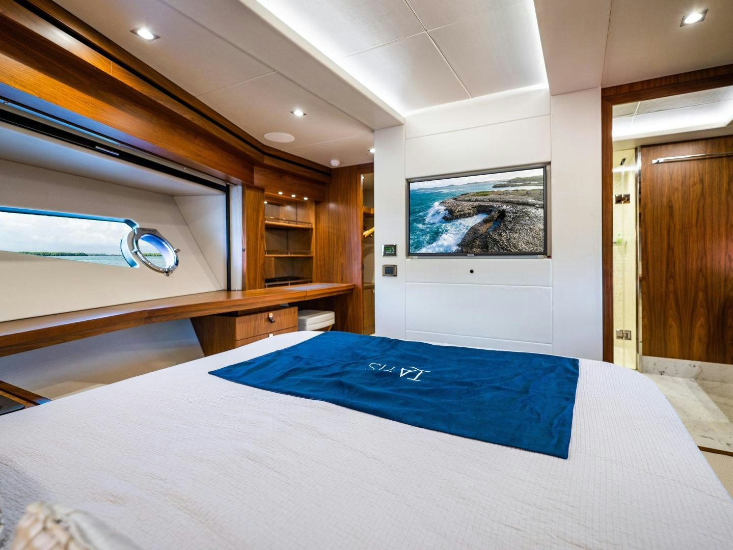 a bed with blue sheets aboard TATIS Yacht for Sale