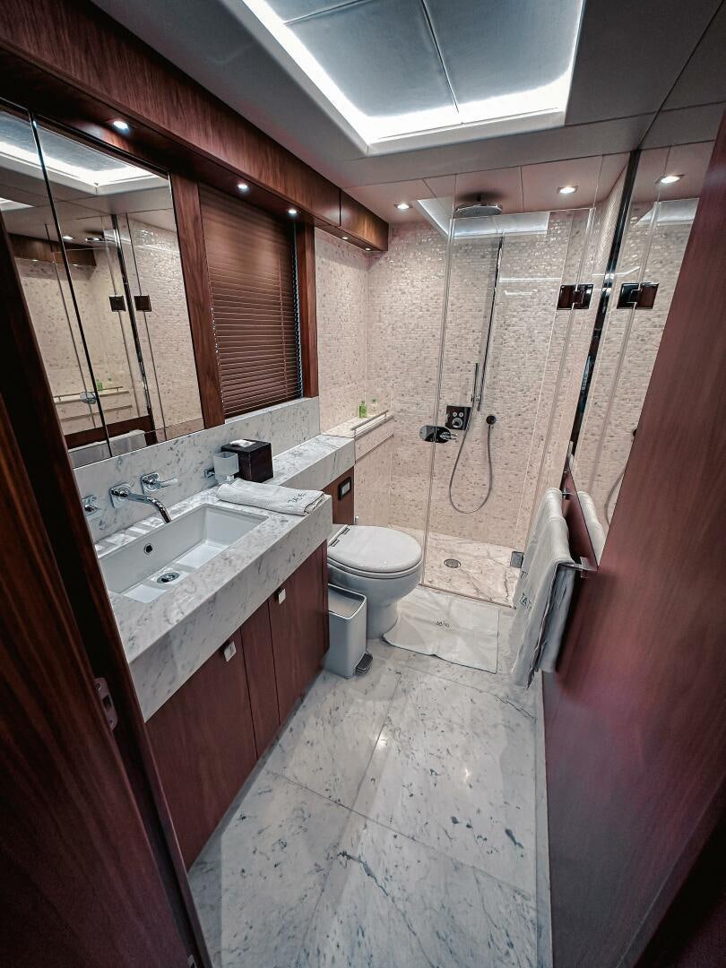 a bathroom with a sink toilet and a mirror aboard TATIS Yacht for Sale