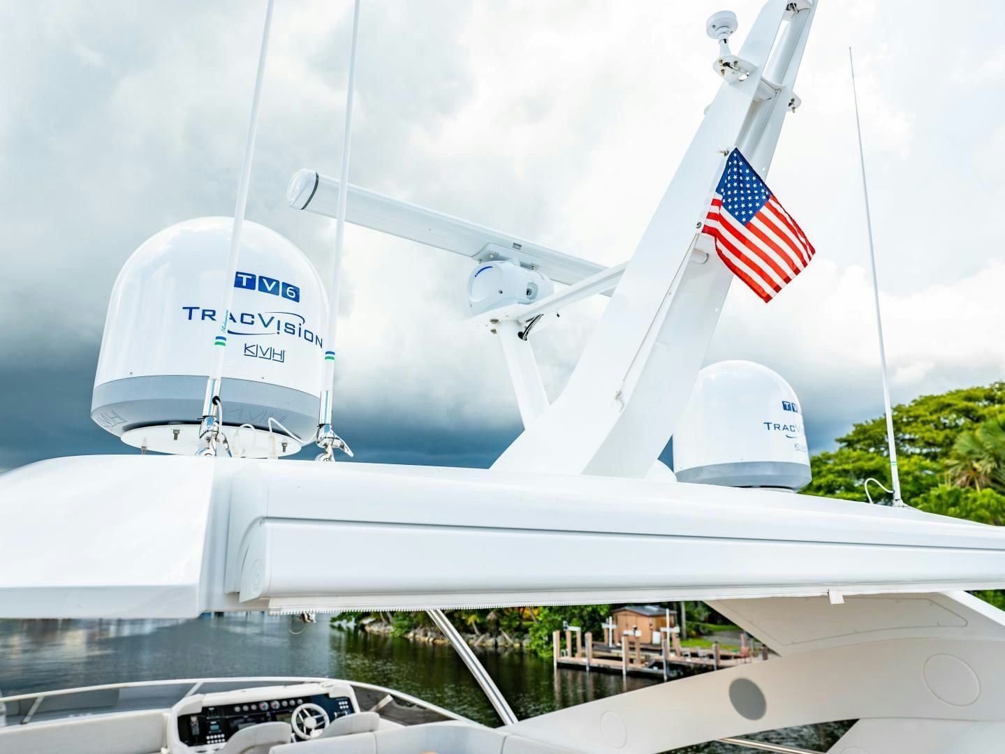 a large white ship with a flag on it aboard TATIS Yacht for Sale