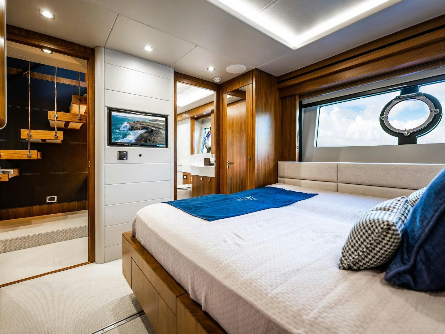 a bedroom with a large mirror aboard TATIS Yacht for Sale