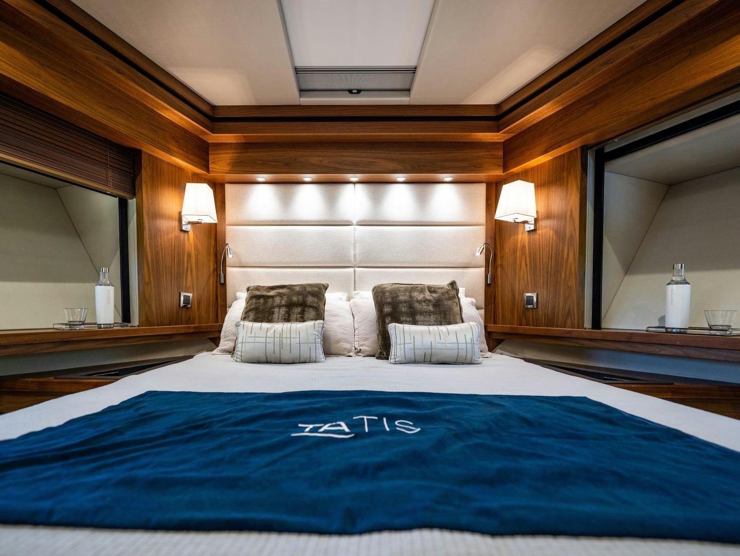 a bed with a blue sheet aboard TATIS Yacht for Sale
