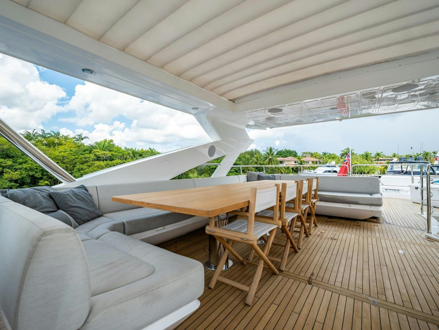 a deck with a table and chairs aboard TATIS Yacht for Sale