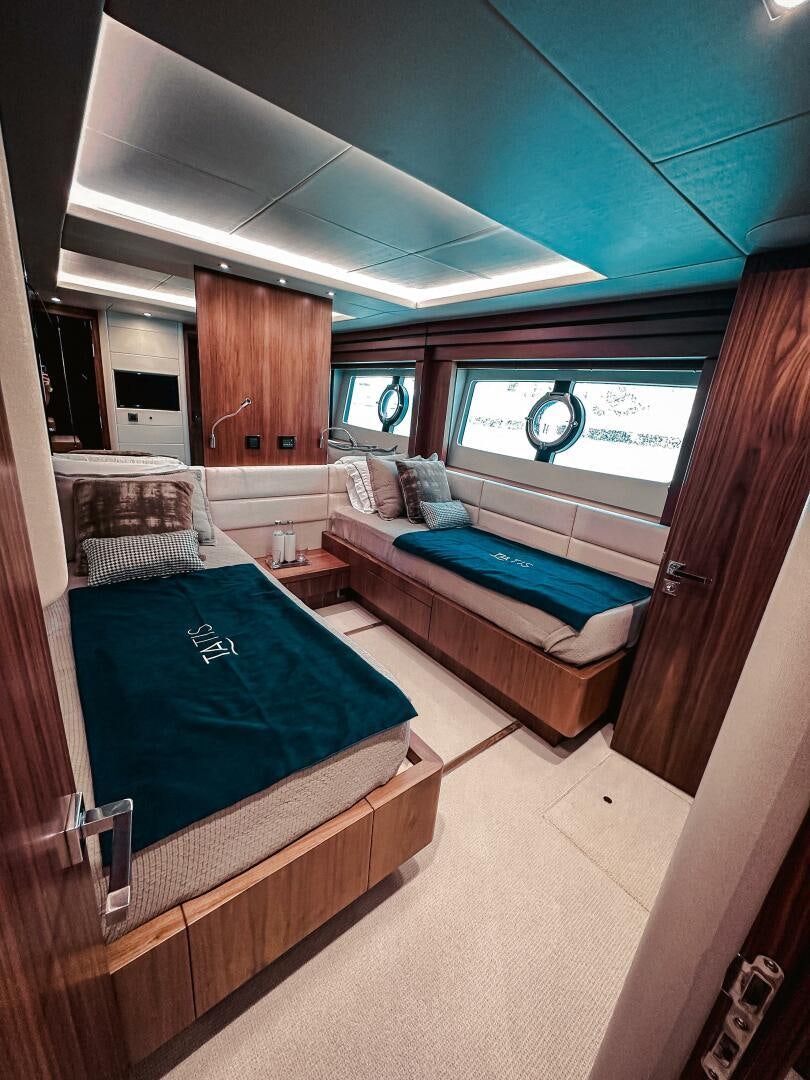 a room with a bed and a window aboard TATIS Yacht for Sale