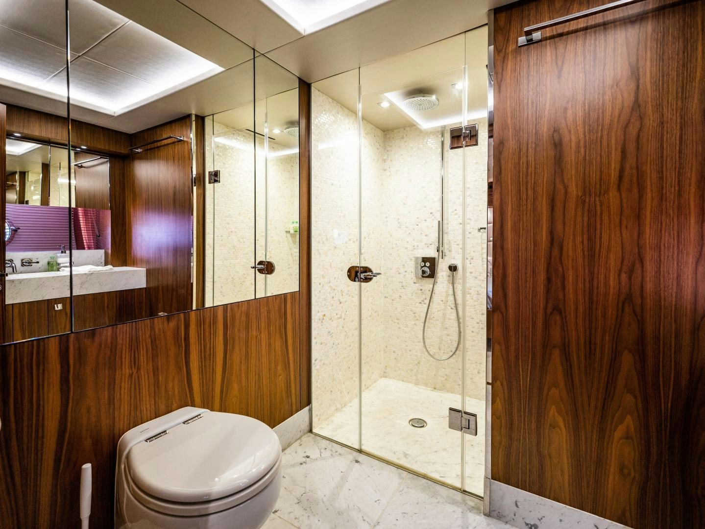 a bathroom with a toilet and shower aboard TATIS Yacht for Sale