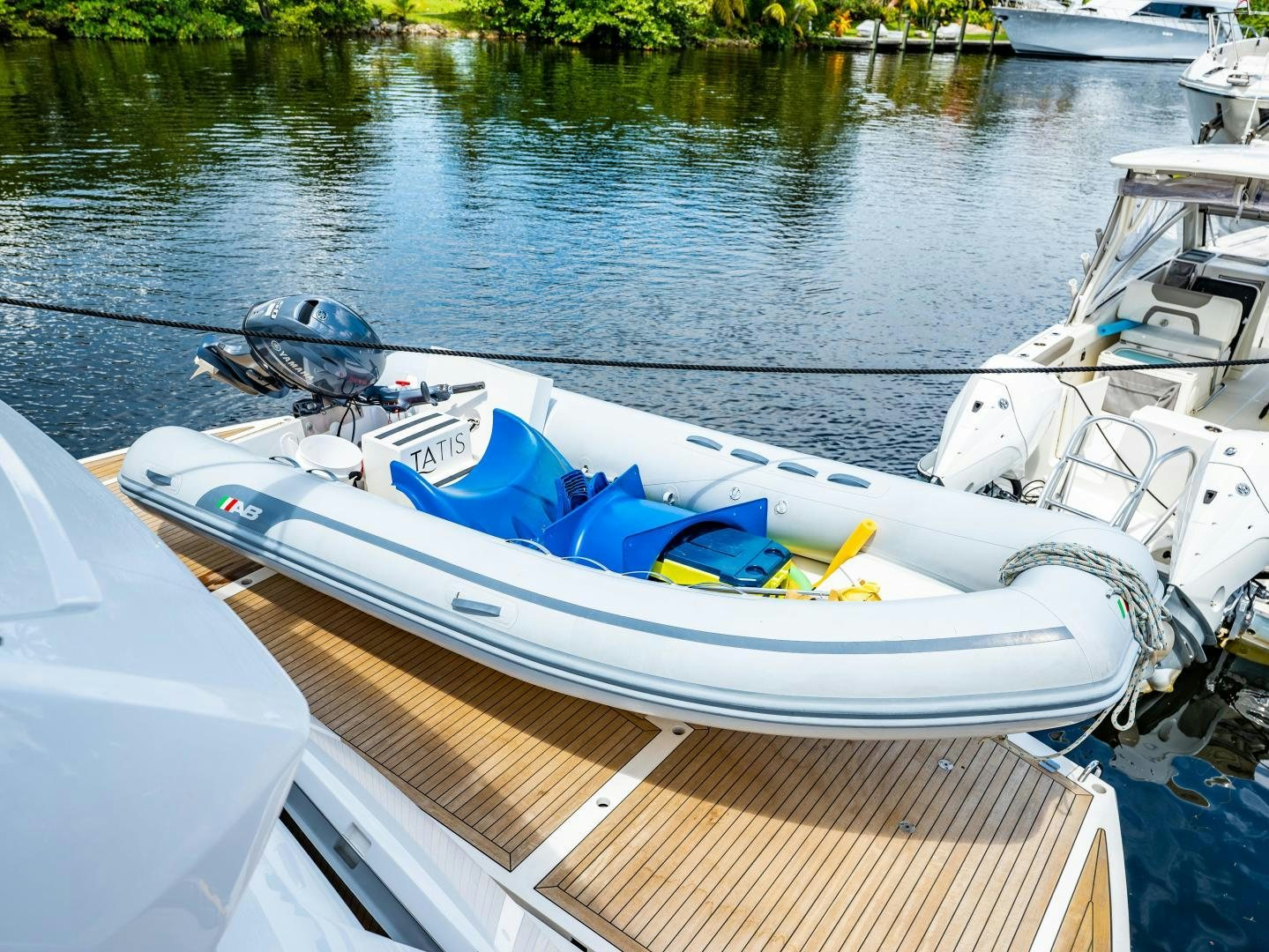 a motorboat with a motor attached to it aboard TATIS Yacht for Sale