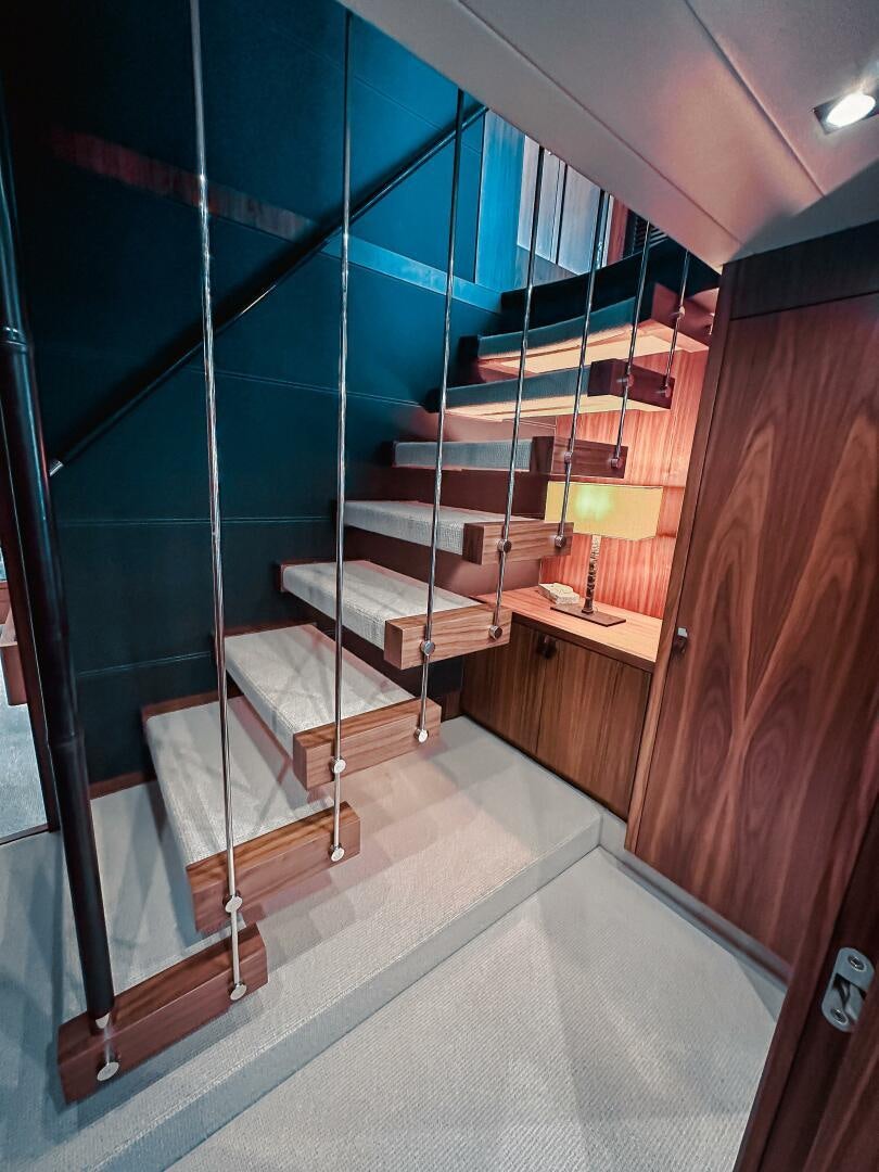 a room with a wood door and a glass wall aboard TATIS Yacht for Sale