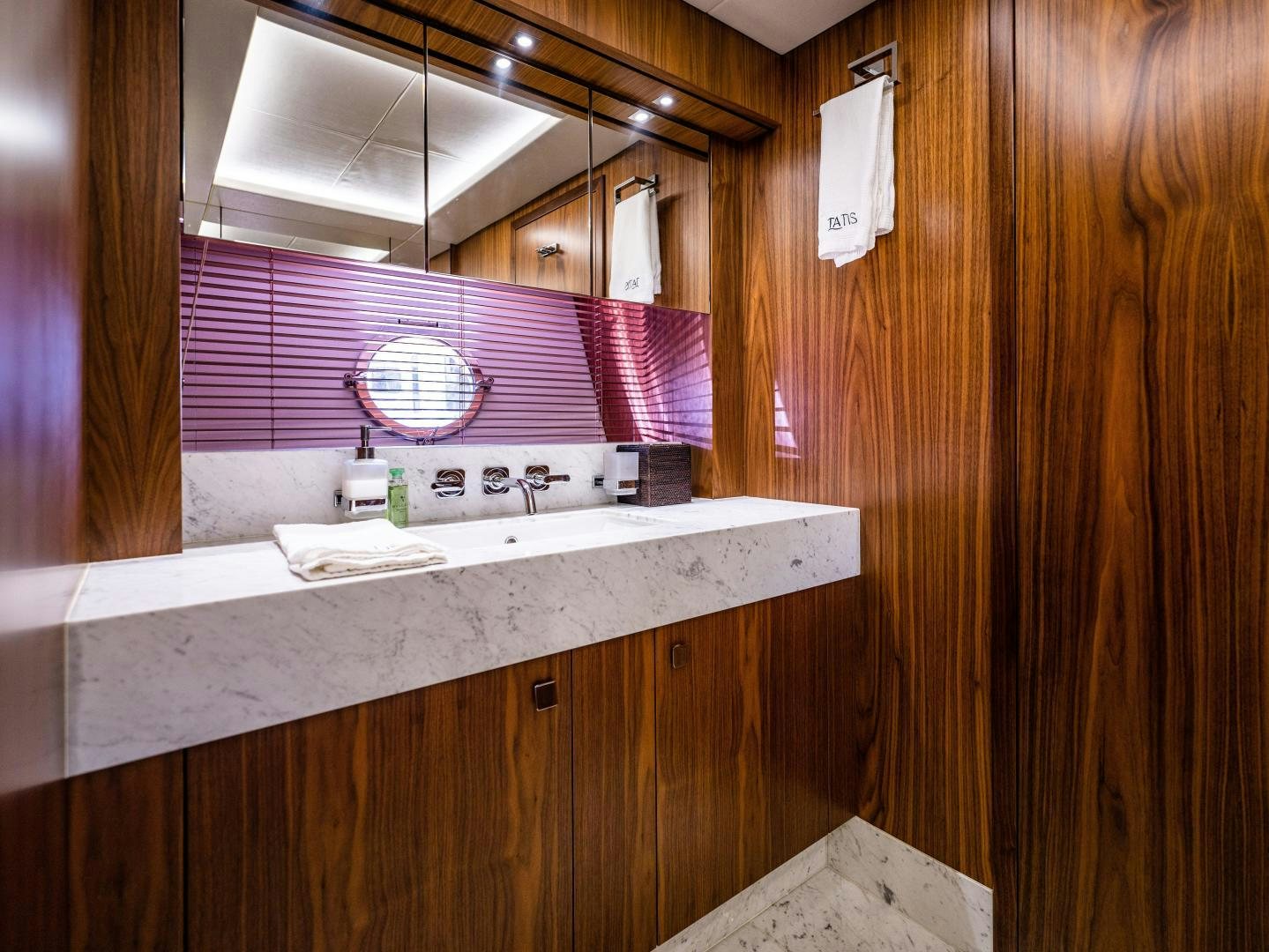 a bathroom with a sink and a mirror aboard TATIS Yacht for Sale