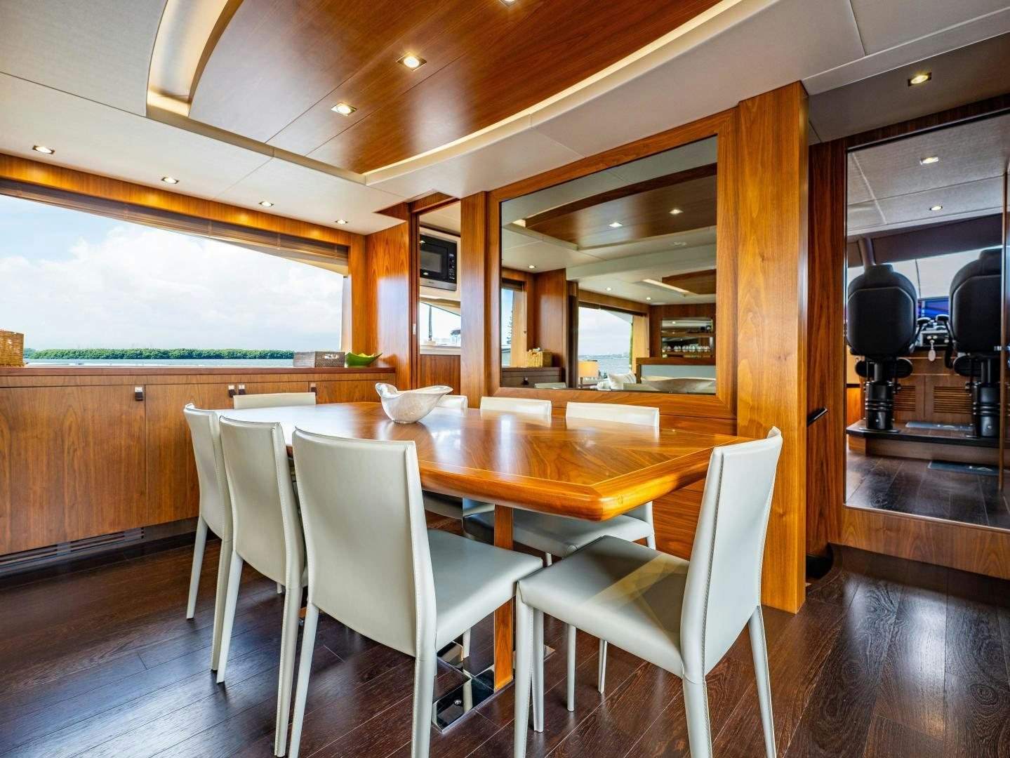 a wood dining table and chairs in a room with wood walls aboard TATIS Yacht for Sale