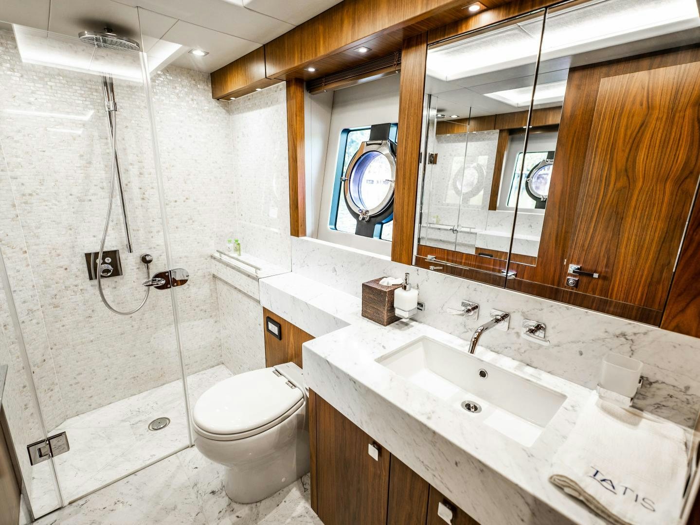 a bathroom with a sink toilet and a mirror aboard TATIS Yacht for Sale