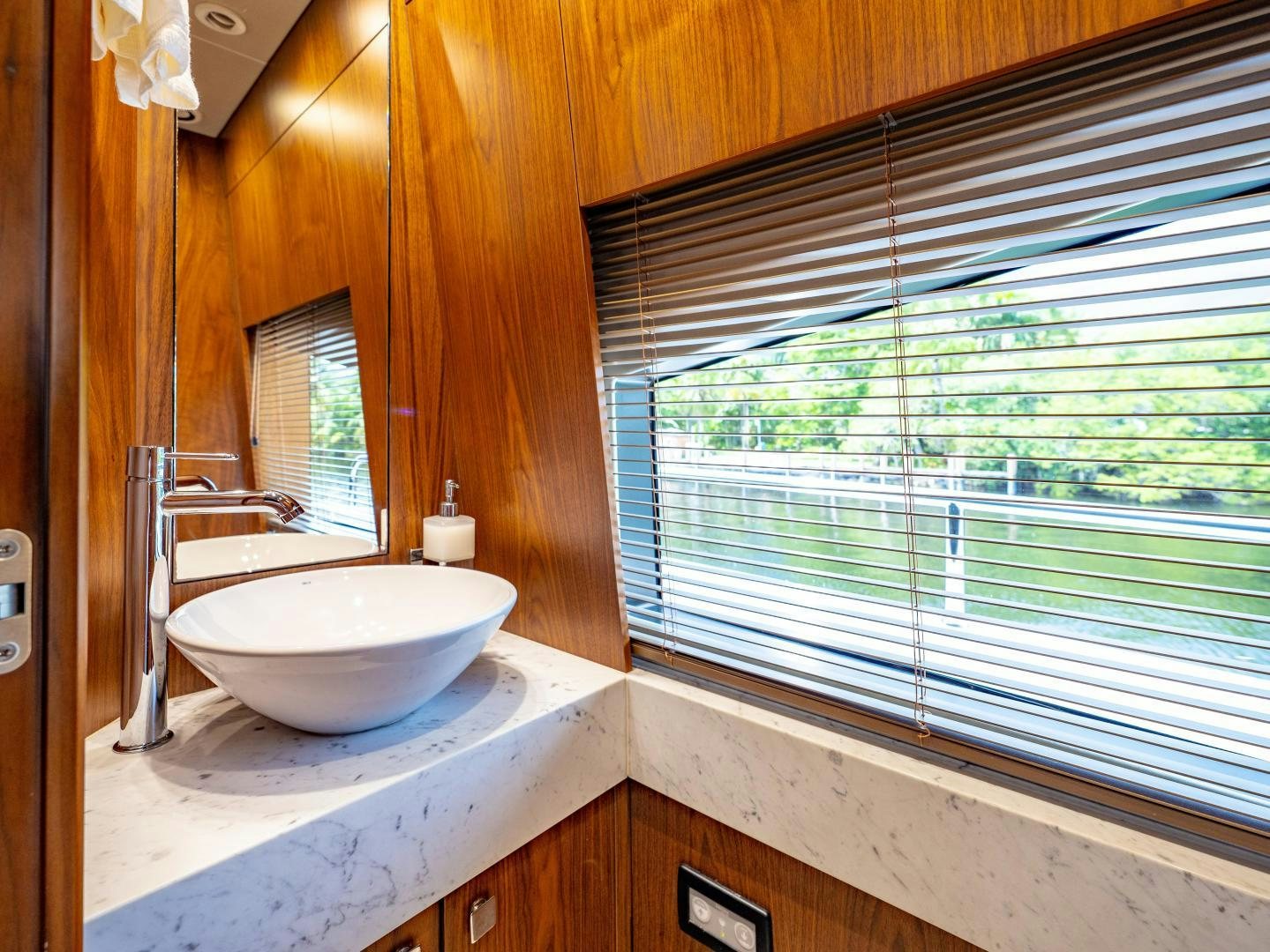 a bathroom with a sink and a window aboard TATIS Yacht for Sale